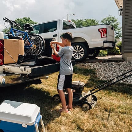 Boy-Loading-Things-On-a-Truck
