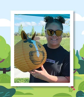 Woman holding a cow shaped lantern