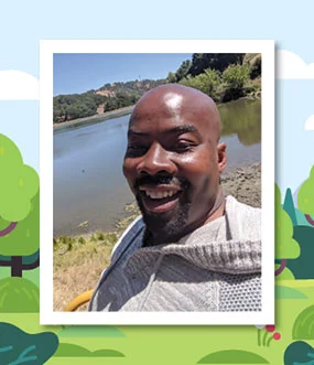 Man standing in front of a lake