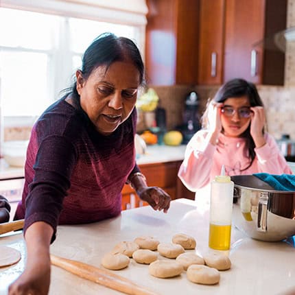 Woman and young girl baking together
