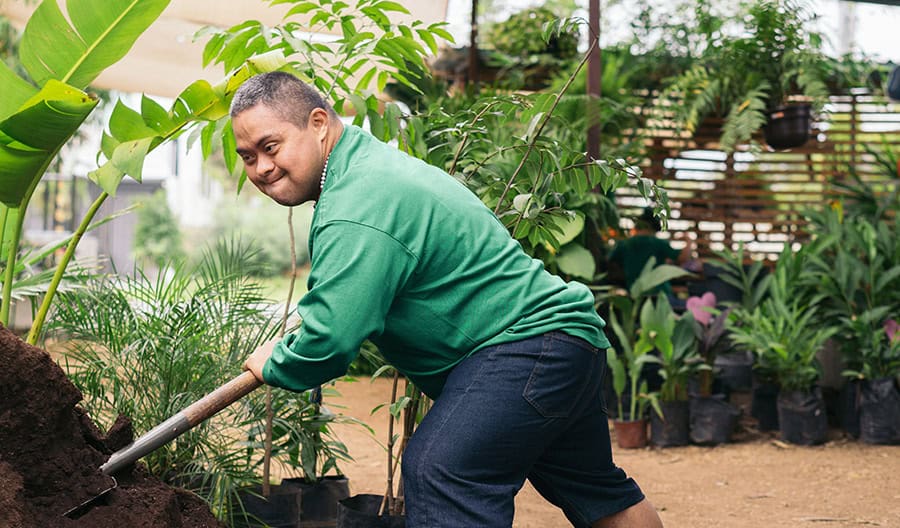 Man-In-Green-Shoveling-Soil
