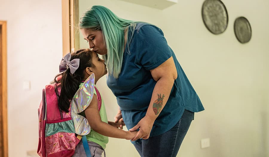 Mom-Kissing-Daughter-On-The-Head