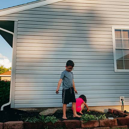 Two-Children-Playing-In-Yard